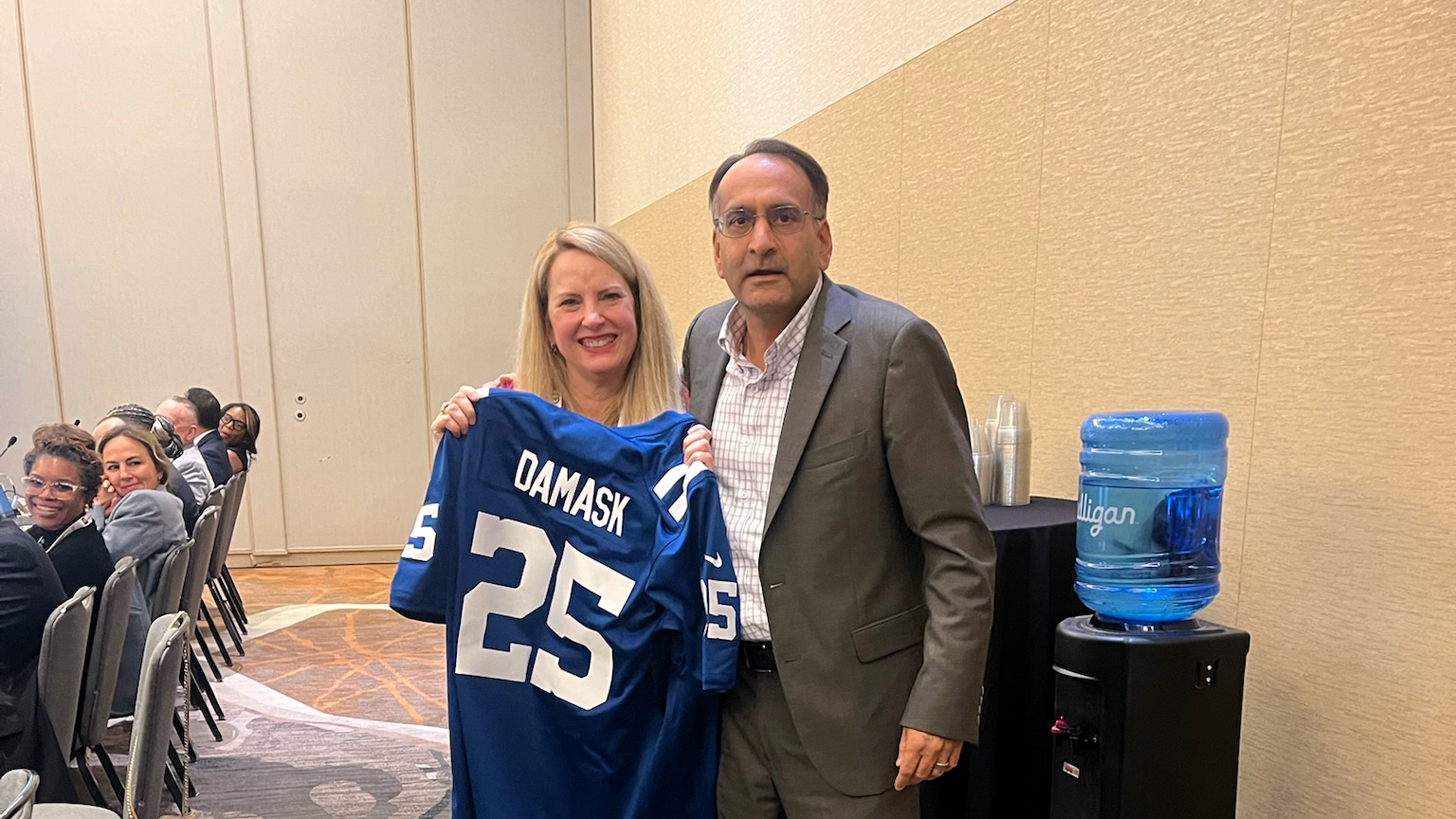 Dr. Damask holding a jersey