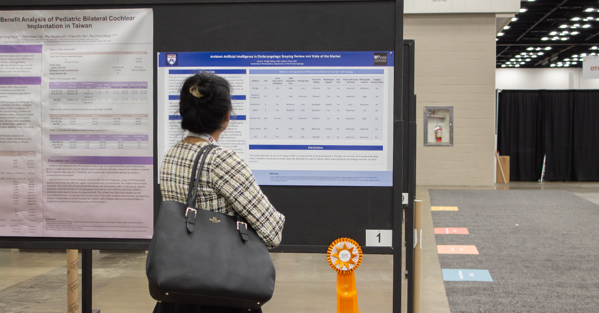 Woman looking at poster awarded with ribbon