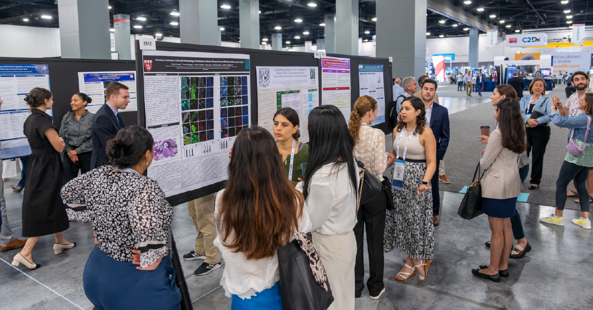 Photo of attendees looking at scientific posters.