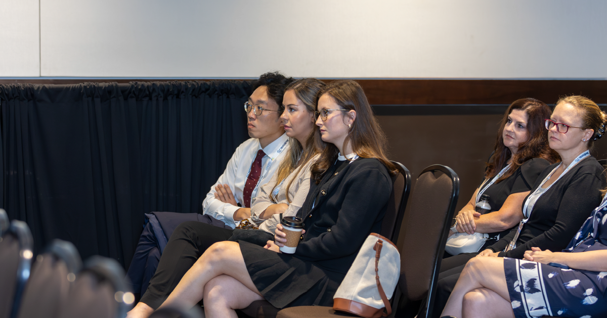 Photo of three attendees listening to an education session.