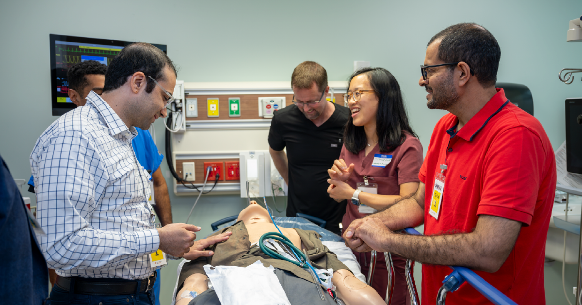 Photo of four attendees participating in a hands-on simulation workshop